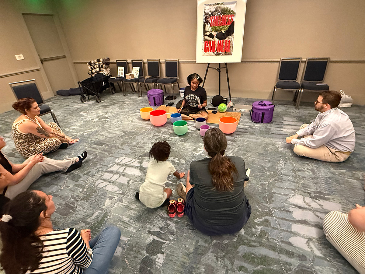 Shawandra Ford leads a sound healing and practice at the conference.